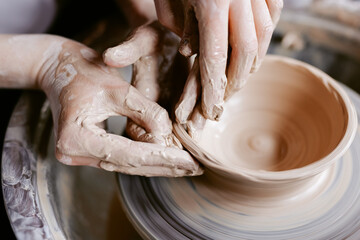 Artist giving shape to pottery product