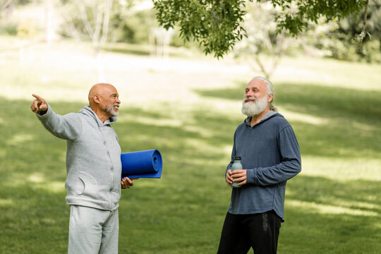 Older Men Chat After A Yoga Class In The Park 