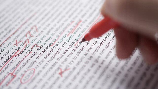 Red Marks on Proofreading English Text Document Closeup