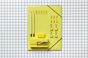 Yellow folder, paper clips, pins, stapler, eraser and pencils