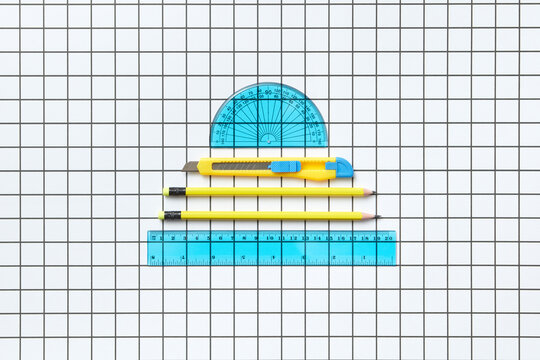 Blue rulers, knife and yellow pencils