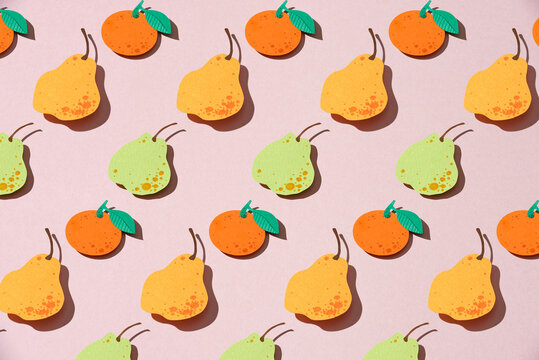 Seamless background with pears and oranges. Fruit made of paper.