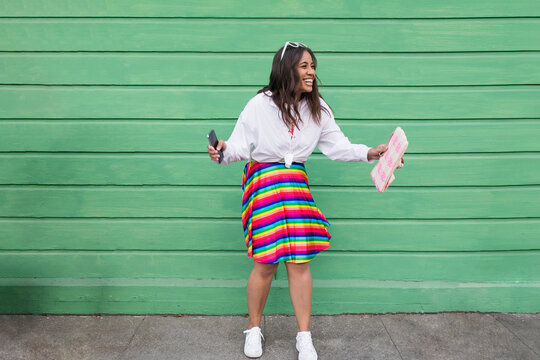 Happy Fijian female laughing outside green cottage