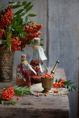 Fresh berries rowan, on wooden background. Ingredient for winter autumn fall seasonal hot drink, immunity alternative medicine beverage.