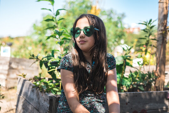 Girl wearing green hearts sunglasses 