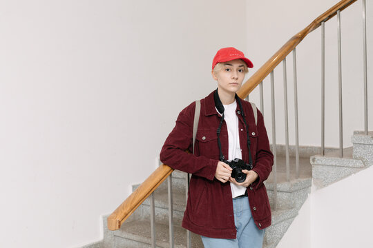portrait of young non binary person holding camera