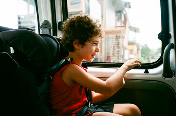 Portrait of a happy boy playing to drive a car