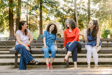 Smiling mature women talking to each other in park
