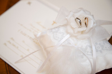 Wedding ring, ring pillow and marriage certificate