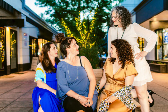 Stylish girlfriends talking during town festive event