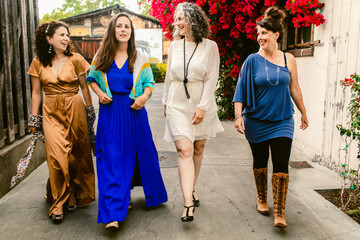 Company of delighted women in fancy dresses