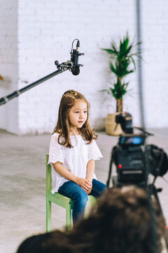 An adorable little girl shooting a professional video