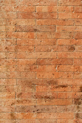 Ancient and unique orange brick wall during a sunny day 