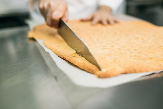 Chef cutting cake layer