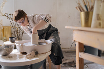 young woman working in a pottery workshop