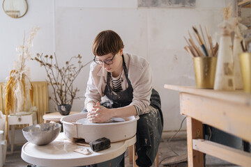 young woman working in a pottery workshop