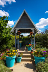Wooden garden gazebo in the garden full of flowers. Photo taken at noon in perfect lighting...