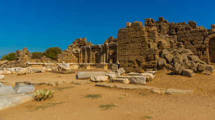 SIDE, TURKEY: Ancient ruins in the city of Side on a sunny summer day against the background of the blue sky.