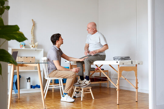 An osteopath and a patient having conversation