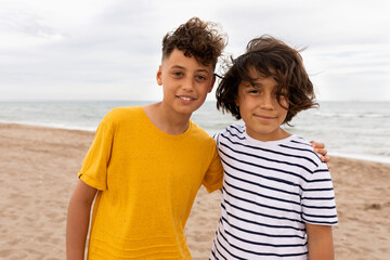 kids posing together looking at camera on the beach