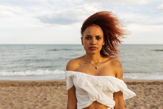 Portrait of black woman looking at camera on the beach