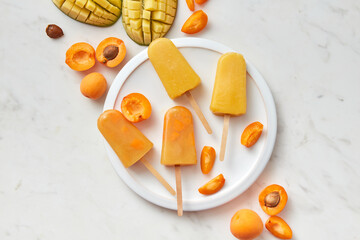 Apricot and mango ice creams and fresh fruits