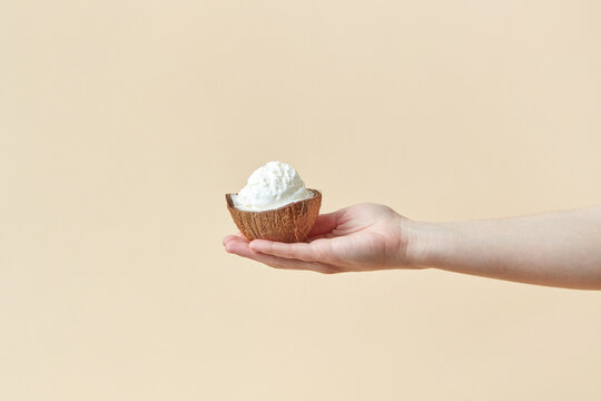 Woman holding ice cream in coconut shell