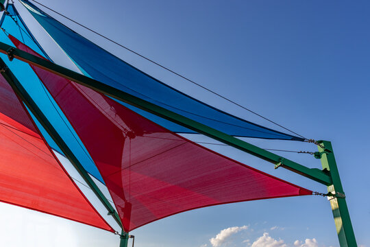 Sun shades in red and blue covering a play yard