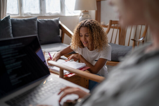 Two women brainstorming ideas at home