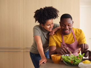 Loving couple making healthy salad