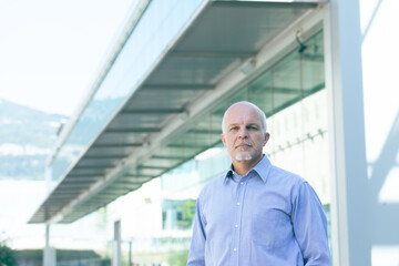 Fototapeta premium Serious businessman with inscrutable stare looking at camera