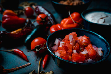 mexican food pico de gallo on bowl wit vegetables in dark food style