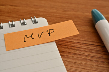 There is sticky note with the word of MVP which is an abbreviation for Minimum Viable Product on...