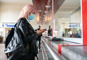 Woman Using Smartphone At Ticket Office