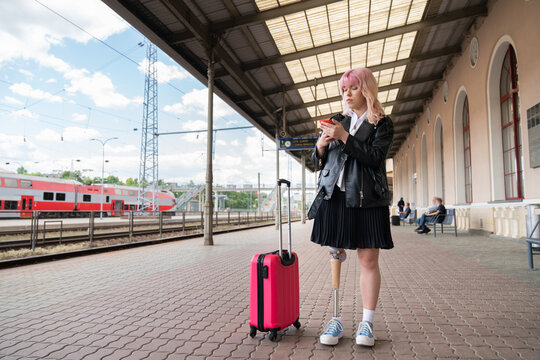 Woman Using Cellphone At Train Station