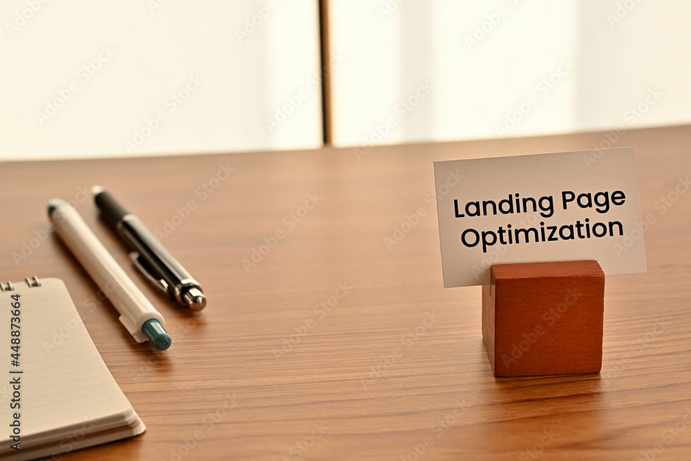Poster there is a card on paper stand with the word of landing page optimization on the desk with a pen.