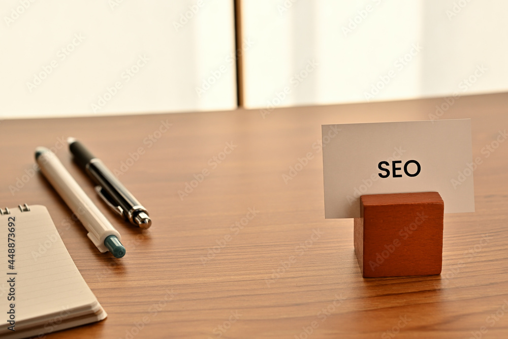 Poster there is a card on paper stand with the word of seo which is an abbreviation for search engine optim