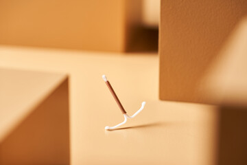 Contraception device on graphic background.