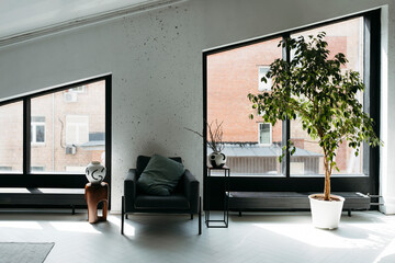 An empty living room with large windows.