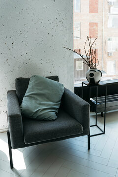 An empty living room with large windows.
