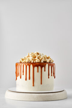Delicious wedding cake with caramel glaze and popcorn