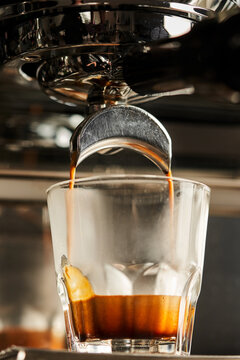 Coffee machine pouring drink in glass