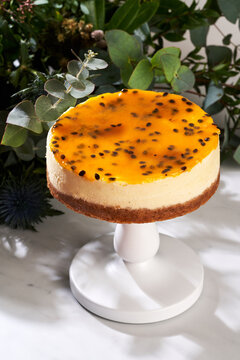 Sweet cheesecake with passion fruit jelly on table