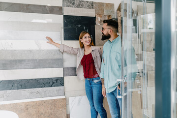 Middle age couple choosing ceramic tiles for their new bathroom