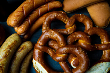 Oktoberfest Pretzels sausages and beer on darkfood style 