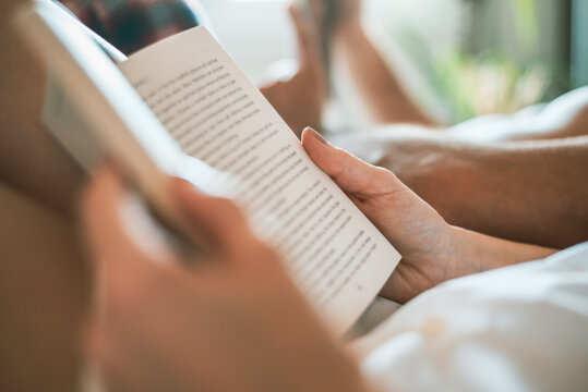 Woman in bed reading a book