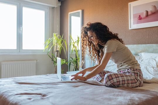 Woman in pajamas with computer
