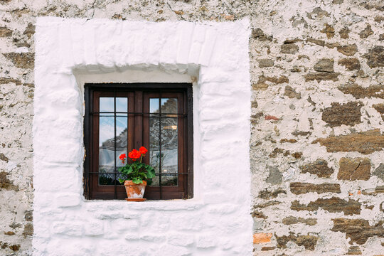 Countryside house window with flower