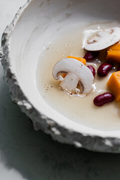 Food: Consome of Ceps, pumpkin gnochi and black beans