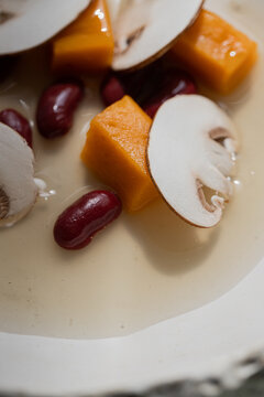 Food: Consome of Ceps, pumpkin gnochi and black beans